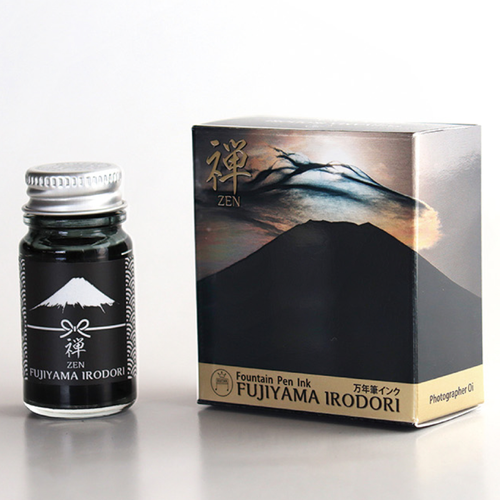 Teranishi Mt. Fuji Fountain Pen Ink in Zen Black. A 12ml glass bottle of deep black ink with a minimalist Mt. Fuji illustration on the label. Encre pour stylo-plume Teranishi Mt. Fuji en Zen Noir. Un flacon de 12 ml d'encre noire profonde avec une illustration du Mont Fuji sur l'étiquette.