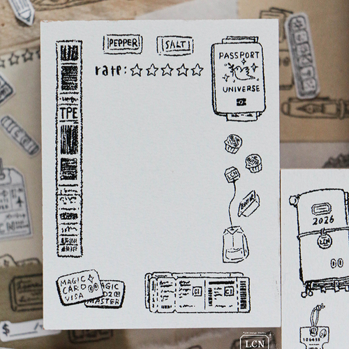 Lin Chia Ning "Travel 1" Rubber Stamp. A large 6.5x5cm vintage-style stamp featuring a frame of luggage tickets, a passport, a plane ticket, and a cup of tea. Tampon en caoutchouc Lin Chia Ning "Voyage 1". Un grand tampon vintage de 6,5x5cm représentant un cadre avec des tickets de bagages, un passeport, un billet d'avion et une tasse de thé.
