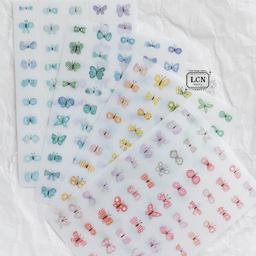 Lin Chia Ning "Shell Butterfly" Print-On Sticker Set. Four sheets of delicate, pressure-activated butterfly and shell-themed transfer stickers. Set de décalcomanies "Shell Butterfly" par Lin Chia Ning. Quatre planches de transferts délicats sur le thème des papillons et des coquillages.