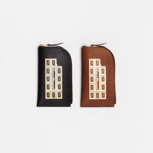 THE SUPERIOR LABOR Stamped Series Zip Case in Chocolate. A handmade vertical L-zip Tochigi leather pouch with bold stamped logo, brass zipper, and vintage industrial details. Pochette zippée THE SUPERIOR LABOR Série Stamped en Chocolat. Une pochette artisanale verticale L-zip en cuir Tochigi avec grand logo estampé, fermeture éclair en laiton et détails industriels vintage.