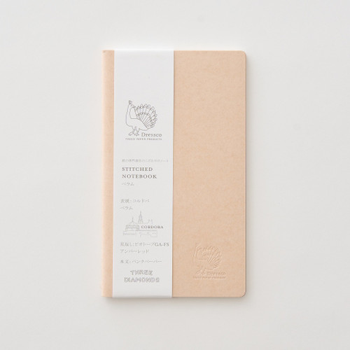 TAKEO PAPER Dressco Stitch Notebook Vellum edition. A slim, palm-sized notebook featuring a leather-textured vellum tan paper cover, stitched spine, and premium blank Bank Paper pages embedded with a Three Diamonds watermark. / Carnet cousu TAKEO PAPER Dressco Édition Vellum. Un carnet de poche mince arborant une couverture en papier vellum beige texture cuir, une reliure cousue et des pages blanches en papier de banque haut de gamme.