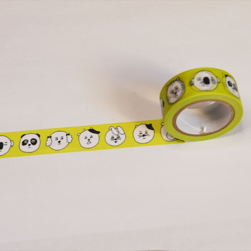 Classiky sennokoto Yellow Face washi masking tape, 1.8cm wide. Features a funny, repeating embroidery pattern of cute, quirky characters and animals with expressive, human-like faces in bright yellow ink on a cream background. / Ruban de masquage washi Classiky sennokoto, motif Yellow Face, 1,8 cm de large. Présente un motif brodé répétitif et amusant de personnages et d'animaux mignons et originaux aux visages expressifs et presque humains à l'encre jaune vif sur fond crème.