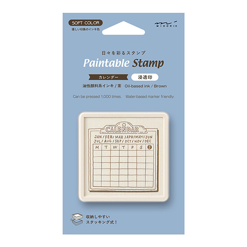 Midori pre-inked paintable stamp Monthly Calendar theme in a brown square body. Shows a soft brown ink blank monthly calendar grid with a Monday start format stamped on paper. / Tampon auto-encreur à peindre Midori thème Calendrier Mensuel, boîtier carré marron. Montre une grille de calendrier mensuel vierge avec un format commençant le lundi à l'encre marron clair imprimée sur du papier.