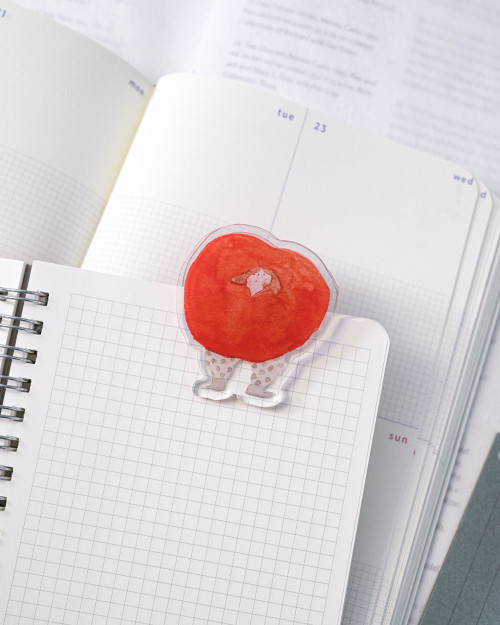 dodolulu Journaling Clip Hearty acrylic memo clip displaying photos and ticket stubs on a desk. / Pince-mémo en acrylique dodolulu Journaling Clip Hearty pour exposer des photos et des billets de concert sur un bureau.