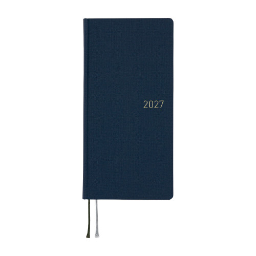 Hobonichi Techo 2027 Weeks Mega Colors: Midnight Blue. Slim expanded hardcover weekly planner in deep navy with white-gold 2027 foil and extra grid memo pages. Hobonichi Techo 2027 Weeks Mega Colors : Midnight Blue. Agenda hebdomadaire mince à couverture rigide bleu marine profond, millésime 2027 en foil or blanc et pages mémo quadrillées supplémentaires.