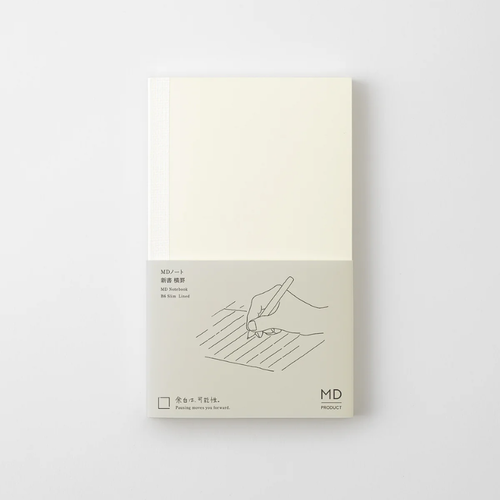 Minimalist Midori MD Notebook in B6 Slim size with lined cream pages. Features a thick center line and an exposed cheesecloth spine that lays flat next to a colorful ribbon bookmark. / Carnet minimaliste Midori MD Notebook de taille B6 Slim avec pages crème lignées. Dispose d'une ligne centrale épaisse et d'un dos en gaze exposé qui repose à plat à côté d'un ruban marque-page coloré.