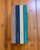 Faded Chronicle 2027 Chronicle Planner B6 Compact edition showing a collection of its 10 unique cover options with an open view of its lay-flat ink-friendly pages. Agenda Faded Chronicle 2027 Chronicle Planner Édition B6 Compact, présentant ses 10 options de couverture uniques et ses pages intérieures plates adaptées aux stylos plume.