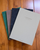 Faded Chronicle 2027 Chronicle Planner A5 Collective edition showing an array of its 10 unique cover designs with an open view of its lay-flat ink-friendly pages. Agenda Faded Chronicle 2027 Chronicle Planner Édition A5 Collective, présentant ses 10 designs de couverture uniques et ses pages intérieures adaptées aux stylos plume.