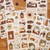 A limited-edition Furukawa Shiko x Kalita Foil-Stamped Sticker Sheet - Black Coffee (QS304) made of Washi paper, featuring coffee-themed illustrations with metallic foil accents. Une feuille d'autocollants gaufrés à chaud (dorés ou argentés) en papier Washi Furukawa Shiko x Kalita - Black Coffee (QS304), en édition limitée, illustrant des motifs de café avec des accents métalliques.