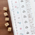 A set of 5 small, square rubber stamps (a-209) designed by Peppoko, featuring weather icons: sun, cloud, rain, snow, and wind. Un ensemble de 5 petits tampons carrés en caoutchouc (a-209) conçus par Peppoko, avec des icônes météo : soleil, nuage, pluie, neige et vent.