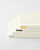 Minimalist MD Notebook A5 with an exposed fabric spine and a cream-colored paper cover wrap. It is shown open 180 degrees flat, displaying its ink-friendly pages. / Carnet minimaliste MD Notebook A5 avec reliure apparente en tissu et couverture en papier crème, ouvert à 180 degrés à plat pour montrer ses pages adaptées aux stylos plume.