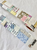 Pion Washi Tape Spring. A 3cm wide washi tape featuring a patchwork collage of floral illustrations and textile patterns in warm spring colors. Ruban adhésif Washi Pion Spring (春野小徑). Un ruban de 3 cm de large présentant un collage patchwork d'illustrations florales et de motifs textiles dans des tons printaniers chauds.