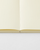 Midori MD Notebook A6 Dot Grid. A minimalist cream-colored pocket notebook featuring subtle 5mm dot grid pages and a thread-bound spine. Carnet Midori MD Notebook A6 Dot Grid. Un carnet de poche minimaliste couleur crème avec des pages à petits points de 5 mm et une reliure cousue.