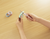 KOKUYO Saxa Poche compact scissors in Light Blue. A slim, pen-shaped tool with a sliding button that reveals stainless steel blades. Ciseaux compacts KOKUYO Saxa Poche en Bleu Clair. Un outil fin en forme de stylo avec un bouton coulissant qui révèle des lames en acier inoxydable.