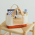 THE SUPERIOR LABOR Engineer Bag Petite. A small, handcrafted canvas tote with leather straps and a hand-painted bottom, available in 10 colors. Sac Engineer Petite par THE SUPERIOR LABOR. Un petit sac cabas en toile avec anses en cuir et fond peint à la main, disponible en 10 couleurs.