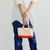 THE SUPERIOR LABOR Engineer Bag Petite. A small, handcrafted canvas tote with leather straps and a hand-painted bottom, available in 10 colors. Sac Engineer Petite par THE SUPERIOR LABOR. Un petit sac cabas en toile avec anses en cuir et fond peint à la main, disponible en 10 couleurs.