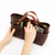THE SUPERIOR LABOR All Leather Mini Bag. A small, premium leather tote bag with a minimalist design and brass hardware, available in two colors. Mini sac tout cuir THE SUPERIOR LABOR. Un petit sac cabas en cuir haut de gamme au design minimaliste avec détails en laiton, disponible en deux couleurs.