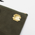 THE SUPERIOR LABOR Paraffin Canvas Pouch #02. A compact, rugged waxed canvas pouch (19x11cm) with a brass zipper, shown in 6 vintage colors. Pochette en toile paraffinée #02 par THE SUPERIOR LABOR. Une petite trousse robuste en toile cirée (19x11cm) avec zip en laiton, en 6 couleurs vintage.
