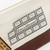 THE SUPERIOR LABOR Engineer Pouch #03 - Chocolate. A long canvas pouch with a hand-painted chocolate bar motif and brass zipper, available in two colors. Pochette Engineer #03 Chocolat par THE SUPERIOR LABOR. Une longue trousse en toile avec un motif de tablette de chocolat peint à la main et zip en laiton.