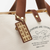 THE SUPERIOR LABOR Engineer Bag Petite in Chocolate. A handmade cotton canvas shoulder bag with leather accents, brass hardware, vintage industrial stamps, and painted bottom. Sac Engineer Petite THE SUPERIOR LABOR en Chocolat. Un sac épaule artisanale en toile de coton avec accents en cuir, quincaillerie en laiton, tampons industriels vintage et fond peint.
