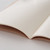 TAKEO PAPER Dressco Stitch Notebook Vellum edition. A slim, palm-sized notebook featuring a leather-textured vellum tan paper cover, stitched spine, and premium blank Bank Paper pages embedded with a Three Diamonds watermark. / Carnet cousu TAKEO PAPER Dressco Édition Vellum. Un carnet de poche mince arborant une couverture en papier vellum beige texture cuir, une reliure cousue et des pages blanches en papier de banque haut de gamme.