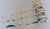 Classiky Shunshun washi masking tape featuring the Shimanami coastal design, 1.8cm wide. Shows a repeating series of minimalist hand-drawn gel pen sketches of islands, waves, and bridges on a translucent cream background. / Ruban de masquage washi Classiky Shunshun, motif côtier Shimanami, 1,8 cm de large. Présente une série répétitive de croquis minimalistes faits à la main au stylo gel représentants des îles, des vagues et des ponts sur un fond crème translucide.