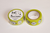 Classiky sennokoto Yellow Face washi masking tape, 1.8cm wide. Features a funny, repeating embroidery pattern of cute, quirky characters and animals with expressive, human-like faces in bright yellow ink on a cream background. / Ruban de masquage washi Classiky sennokoto, motif Yellow Face, 1,8 cm de large. Présente un motif brodé répétitif et amusant de personnages et d'animaux mignons et originaux aux visages expressifs et presque humains à l'encre jaune vif sur fond crème.