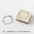 Midori pre-inked paintable stamp Bread theme in a brown square body. Shows a soft brown ink frame pattern with hand-drawn bakery motifs designed by Sayo Koizumi. / Tampon auto-encreur à peindre Midori thème Pain, boîtier carré marron. Montre un motif de cadre à l'encre marron clair avec des motifs de boulangerie conçus par Sayo Koizumi.