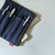 Luddite Denim Bendy Pen Case in unique Random Patchwork Okayama denim from the Authentic Denim series. Compact foldable design that opens flat into a pen tray, featuring a YKK zipper and vintage workwear stitching. Each piece has unique pattern placement. Made in Japan. Étui à stylos Bendy en denim Okayama au motif Random Patchwork unique de la série Authentic Denim. Design compact pliable qui s’ouvre à plat en plateau à stylos, avec fermeture éclair YKK et coutures workwear vintage. Chaque pièce présente un placement de motif unique. Fabriqué au Japon.