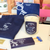 85 Rue Tranquille x ISSMEN Journaling Ritual Set including a canvas tote bag, a scented candle, a blue-tipped matchbox, and an art postcard. / Coffret Rituel de Journaling 85 Rue Tranquille x ISSMEN comprenant un sac cabas en toile, une bougie parfumée, une boîte d'allumettes à bout bleu et une carte postale artistique.