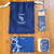 85 Rue Tranquille x ISSMEN Journaling Ritual Set including a canvas tote bag, a scented candle, a blue-tipped matchbox, and an art postcard. / Coffret Rituel de Journaling 85 Rue Tranquille x ISSMEN comprenant un sac cabas en toile, une bougie parfumée, une boîte d'allumettes à bout bleu et une carte postale artistique.