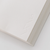 TAKEO PAPER SIKI Notebook M in Yuki Snow showcasing its unique sloped side profile with 53 different white textured paper pages. / Carnet TAKEO PAPER SIKI Taille M thème Yuki Neige montrant son profil en biseau unique composé de 53 pages de papiers blancs aux textures différentes.