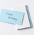 TAKEO PAPER SIKI Notebook M in Tsuyu Rainy Blue showcasing its unique sloped side profile featuring 51 different blue and cool-toned textured paper sheets. / Carnet TAKEO PAPER SIKI Taille M thème Tsuyu Pluie Bleue montrant son profil en biseau unique composé de 51 feuilles de papiers bleus aux textures différentes.