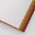 TAKEO PAPER SIKI Notebook M in Minori Harvest showcasing its unique sloped side profile featuring 48 different warm earth-toned textured paper sheets. / Carnet TAKEO PAPER SIKI Taille M thème Minori Récolte montrant son profil en biseau unique composé de 48 feuilles de papiers aux tons chauds et aux textures différentes.