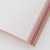 TAKEO PAPER SIKI Notebook M in Hanami Full Bloom showcasing its unique sloped side profile featuring 48 different soft pink and spring floral-toned paper sheets. / Carnet TAKEO PAPER SIKI Taille M thème Hanami Pleine Floraison montrant son profil en biseau unique composé de 48 feuilles de papiers aux tons roses et floraux printaniers.