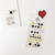 Suatelier Sticker sheet featuring vibrant round smiley faces and playful emoji expressions. / Planche d'autocollants Suatelier présentant des émoticônes et des visages souriants meublés dans des formes rondes vibrantes.