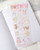 dodolulu Matte Sticker Sheet Little Something featuring a charming assortment of everyday treasures and tiny objects. / Planche d'autocollants mats dodolulu Little Something présentant un assortiment charmant de trésors du quotidien et de petits objets.