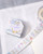 dodolulu Label Sticker Roll Reverie made of textured washi paper with shimmering foil stamping featuring 8 repeating designs. / Rouleau d'étiquettes autocollantes dodolulu Reverie en papier washi texturé avec dorure étincelante présentant 8 motifs répétés.