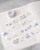 dodolulu doremi PET Tape Miles Away featuring pre-cut glossy clear stickers with whimsical watercolor travel and daydream illustrations. / Ruban PET pré-découpé dodolulu doremi Miles Away présentant des autocollants transparents brillant avec des illustrations à l'aquarelle de voyage et de rêverie.