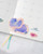 dodolulu 2027 Monthly Calendar Stickers set featuring 12 die-cut calendar cards and 15 decorative stickers with a subtle sand glitter finish in a keepsake box. / Ensemble d'autocollants calendrier mensuel 2027 dodolulu comprenant 12 cartes de calendrier découpées et 15 autocollants décoratifs avec une finition pailletée sablée dans une boîte souvenir.