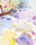 dodolulu 2027 Monthly Calendar Stickers set featuring 12 die-cut calendar cards and 15 decorative stickers with a subtle sand glitter finish in a keepsake box. / Ensemble d'autocollants calendrier mensuel 2027 dodolulu comprenant 12 cartes de calendrier découpées et 15 autocollants décoratifs avec une finition pailletée sablée dans une boîte souvenir.