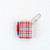 Hobonichi Techo Mini Keychain Bright Plaid. Miniature bright-plaid techo keychain with butterfly-stopper holders, a writable 40-page grid notebook and a removable brass ball chain. Mini porte-clés Hobonichi Techo Bright Plaid. Mini techo à carreaux vifs avec porte-stylos papillon, carnet quadrillé de 40 pages et chaînette en laiton amovible.