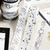 BGM Monotone Washi Tape Starry Sky (1.5 cm). A 15 mm × 5 m black-and-white foil-stamped washi roll of a starry night sky. Ruban washi BGM Monotone Starry Sky (1,5 cm). Rouleau washi 15 mm × 5 m noir et blanc, dorure, motif de ciel étoilé.