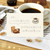 BGM Today’s Cafe Sticker Set Home Cafe. A foil-stamped flake pack of 45 home-café stickers (15 designs × 3) in a 90 × 100 mm sleeve. Set d’autocollants BGM Today’s Cafe Home Cafe. 45 stickers café à la maison dorés (15 motifs × 3), pochette 90 × 100 mm.