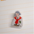 La Dolce Vita Acrylic Clip Red Scarf. A 3 mm acrylic clip about 50 × 50 mm, printed with a girl in a red scarf. Pince acrylique La Dolce Vita Red Scarf. Pince acrylique 3 mm, env. 50 × 50 mm, fille au foulard rouge.