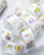 dodolulu 2027 365 Daily Washi Tape Calendar set featuring two rolls of perforated daily washi tape stickers with release paper backing. / Ensemble de rubans washi calendrier 2027 365 jours dodolulu comprenant deux rouleaux d'autocollants perforés quotidiens sur papier protecteur.