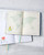 dodolulu 2027 Weekly and Monthly Planner B6 with soft PU cover and full-color illustrated interior pages. / Agenda hebdomadaire et mensuel 2027 B6 dodolulu avec couverture souple en PU et pages intérieures illustrées en couleurs.