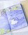 dodolulu 2027 Weekly and Monthly Planner B6 with soft PU cover and full-color illustrated interior pages. / Agenda hebdomadaire et mensuel 2027 B6 dodolulu avec couverture souple en PU et pages intérieures illustrées en couleurs.
