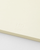 Minimalist Midori MD Notebook in B6 Slim size with lined cream pages. Features a thick center line and an exposed cheesecloth spine that lays flat next to a colorful ribbon bookmark. / Carnet minimaliste Midori MD Notebook de taille B6 Slim avec pages crème lignées. Dispose d'une ligne centrale épaisse et d'un dos en gaze exposé qui repose à plat à côté d'un ruban marque-page coloré.