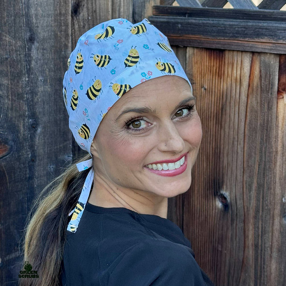 Woman looking over her right shoulder while wearing Tieback Hat - Bee Happy